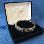 Impressive 14 carat yellow gold bangle set with amethyst, garnet, topaz, citrine and tourmaline