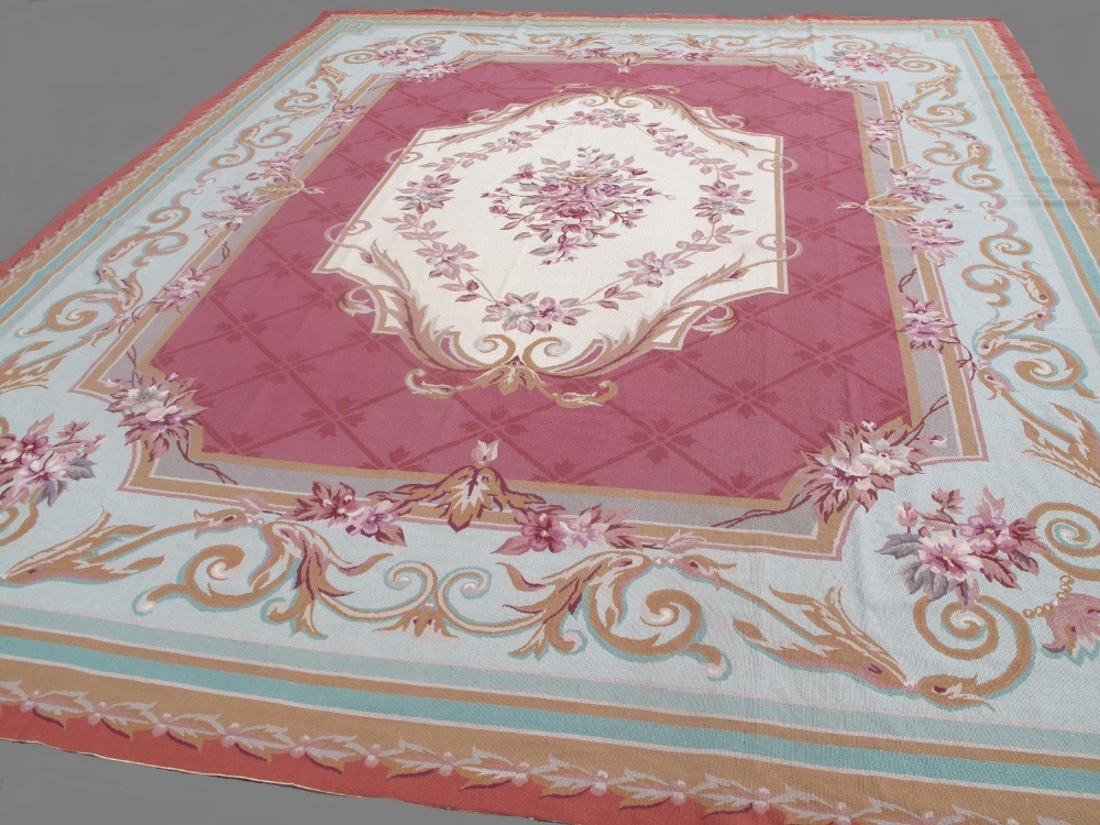 Finely hand woven needlepoint carpet of Aubusson style, with central cream floral medallion,