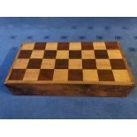 Walnut folding games case with chequered top and back gammon interior with a set of draughts