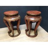 Pair of large Chinese red lacquered circular urn stands with floral decoration, the tops 45cm diam x