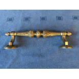 An ornate cast brass Regency style door handle with pineapple finials, 31cmL