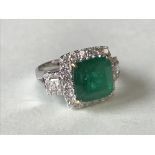 Fine 18 carat white gold, emerald and diamond ring, the central emerald of 4 carats surrounded by
