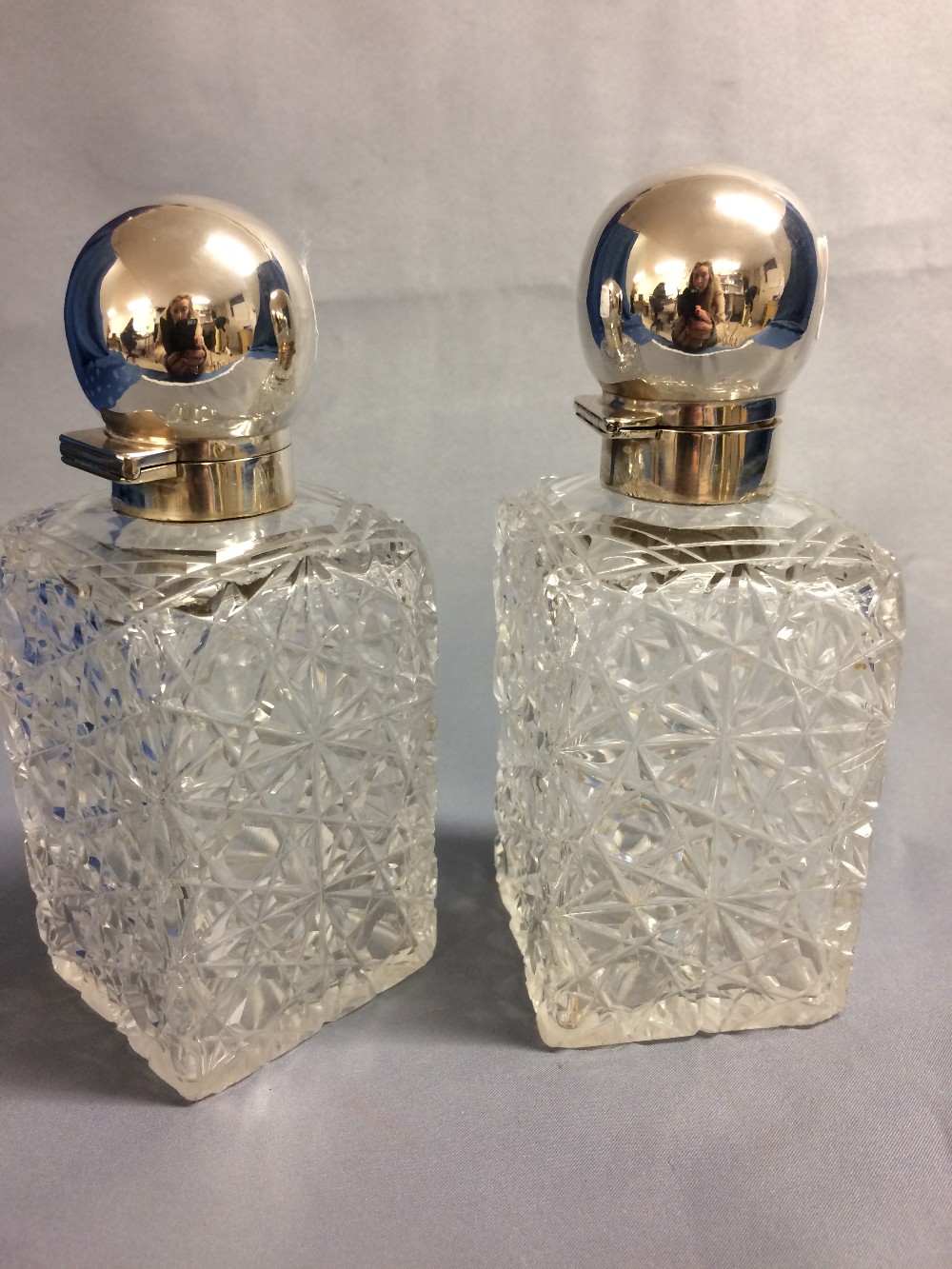 Pair of Victorian square glass cologne bottles with hallmarked silver hinged lids, Sheffield 1892+3