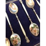 Cased set of 8 enamelled teaspoons with foliate decoration