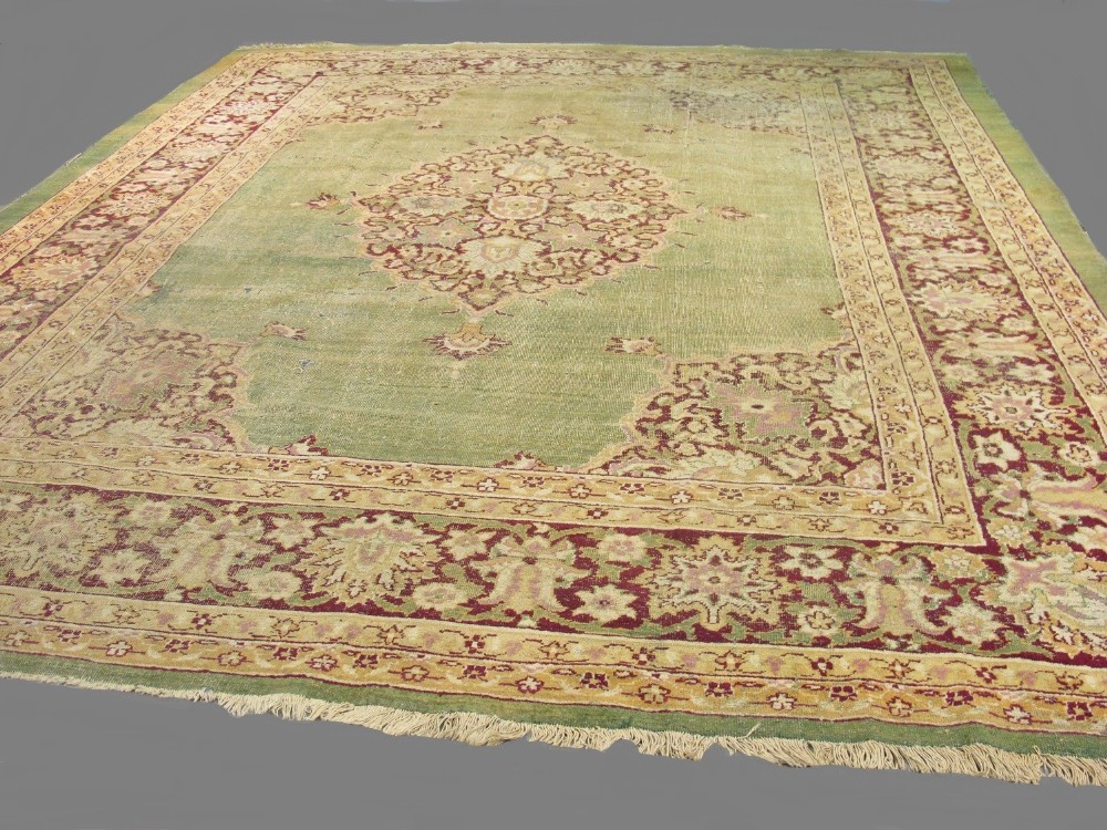 Rare C19th Indian Agra carpet, with all over light green ground with cream, beige and red