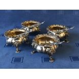 Set of 4 George IV hallmarked silver everted melon panelled salts on cast mask legs with shell