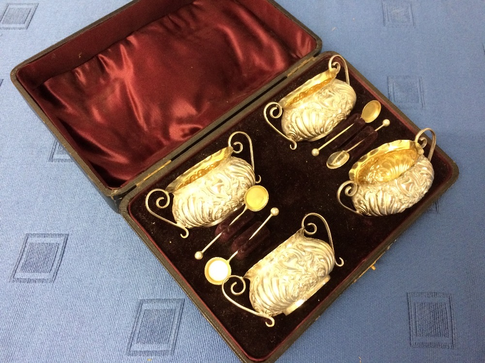 Cased set of 4 hallmarked silver embossed table salts & spoons