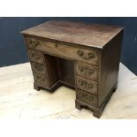 George III mahogany knee hole writing desk of 1 long & 6 short drawers surrounding a cupboard on