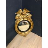 Antique Irish gilded convex wall mirror with ball decoration beneath a scrolling & eagle finial,