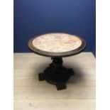 Chinese hardwood marble top circular table with figural, prunus & temple dog carved pedestal on claw