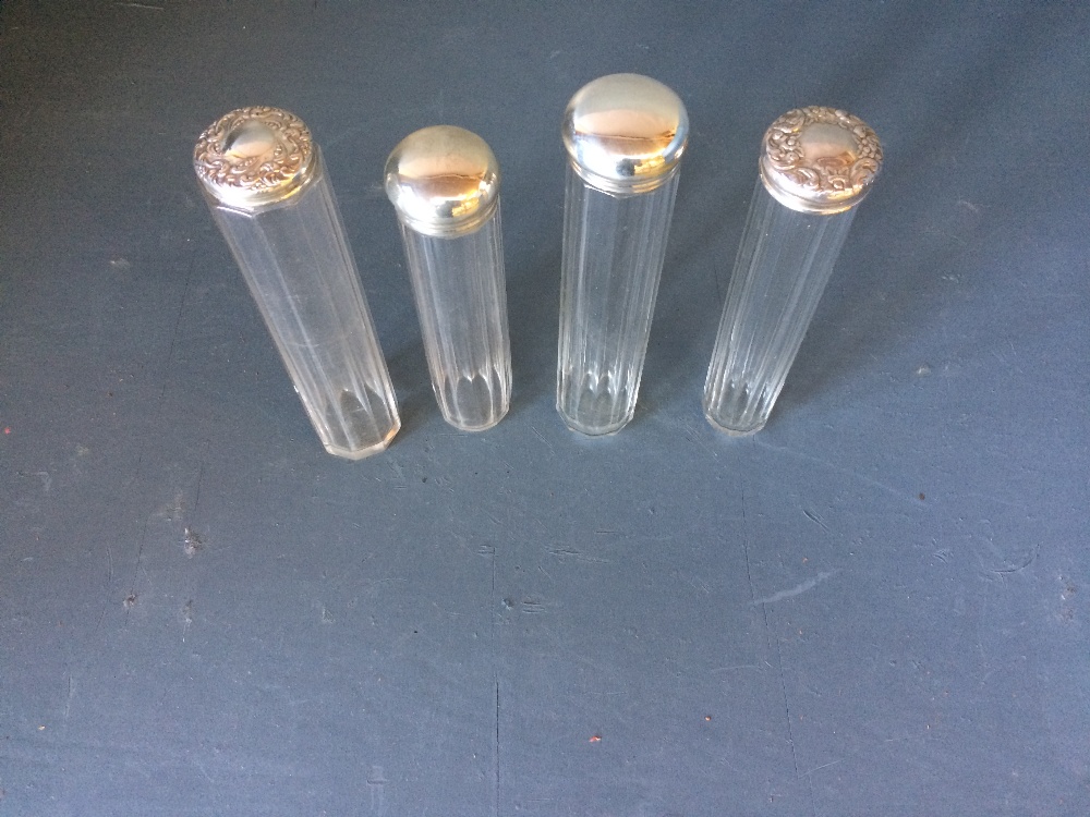 Set of 4 ladies glass vanity bottles with hallmarked silver tops