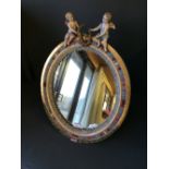Free standing Meissen mirror with floral surrounds surmounted with a pair of cherubs