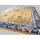 Chinese carpet, circa 1920s, yellow field with sprays of flowers and navy main border, 3.56x2,77