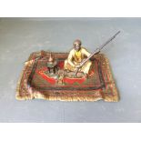 Cold painted bronze figure of a Turkish man, seated on a rug with his rifle, stamped underneath to