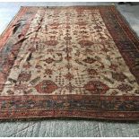 Large Palace rug with central cream ground and all over medallions in reds & blues, wide green & red