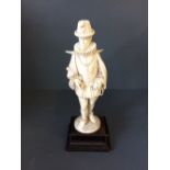 Late C19th/early C20th ivory carving of European figure on wooden base, 37cmH
