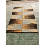 Contemporary rug with square and rectangular designs in browns and blues 234 x 158 cm