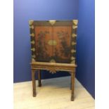 Chinese black lacquered cabinet on stand in the C18th style, the upper section with drawers & pigeon