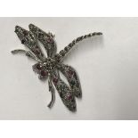 Silver dragonfly brooch made up of many gemstones