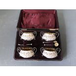 Cased set of 4 hallmarked silver embossed table salts & 4 spoons