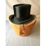 Black silk top hat in a leather bucket shaped hat box, size 6 7/8