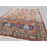 Fine Caucasian rug, with terracotta colour ground and all over medallions of blues and creams &