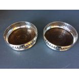 Pair of hallmarked silver bottle coasters with pierced rims, London 1966