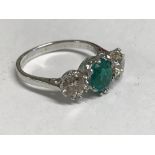 18 carat three stone emerald & diamond ring, the central emerald of 2 carats flanked by 1.5 carats