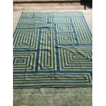 Contemporary rug with bright blue ground and geometric maze patterns in yellow 305 x 247 cm