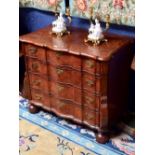 C18th walnut chest of shaped serpentine outline fitted four long drawers on later bun feet, 88cmW