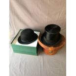 Black silk top hat by Andre & Cottell, Piccadilly London, in leather bucket shaped hat box & black