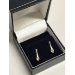 Pair of 14 carat white gold diamond drop earrings