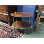 Small two tier mahogany oval occasional table with brass edging, legs & castors, 62Lx56Hcm