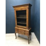 C18th walnut glass fronted cupboard on a later stand with 2 candle slides and 4 small drawers, brass
