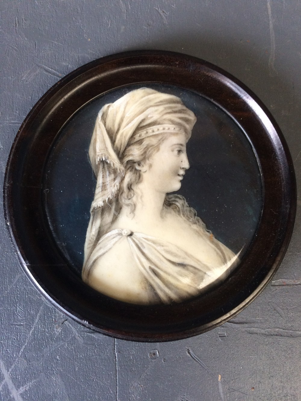 C19th Continental School, portrait miniature of a 'Lady' in profile, en grisaille