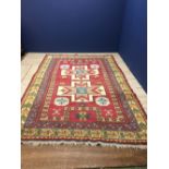 Contemporary patterned rug with central red panel, star shaped motifs and yellow & green patterned