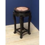 Carved Chinese hardwood stand topped with marble, 62H x 40cm dia