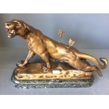 After C. VALTON, bronze lioness with 2 pierced arrows in its back, signed on marble plinth base