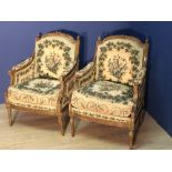 Pair of C19th French Bergere chairs with traces of paint & gilding, with floral needlework