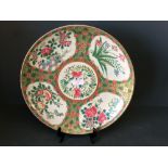 A Chinese plate decorated with a floral motif, 33.5cm dia