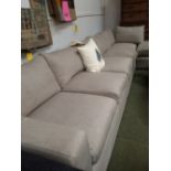 L-shaped sofa upholstered in neutral fabric