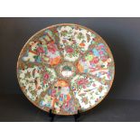 A Canton plate decorated with figures, birds & butterflies, 34cm dia.