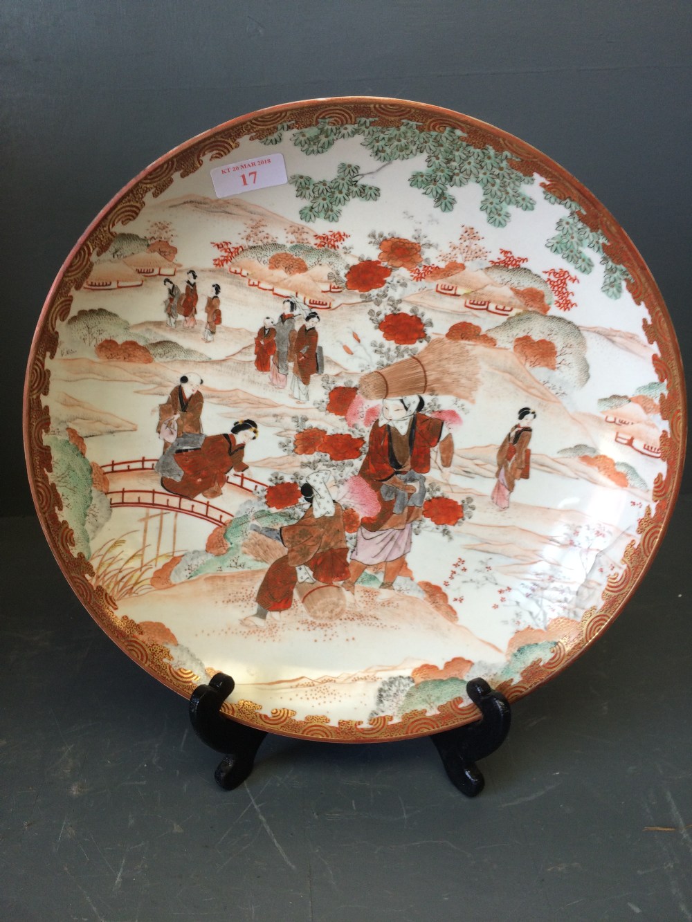 Japanese Kutani plate decorated with figures in a landscape