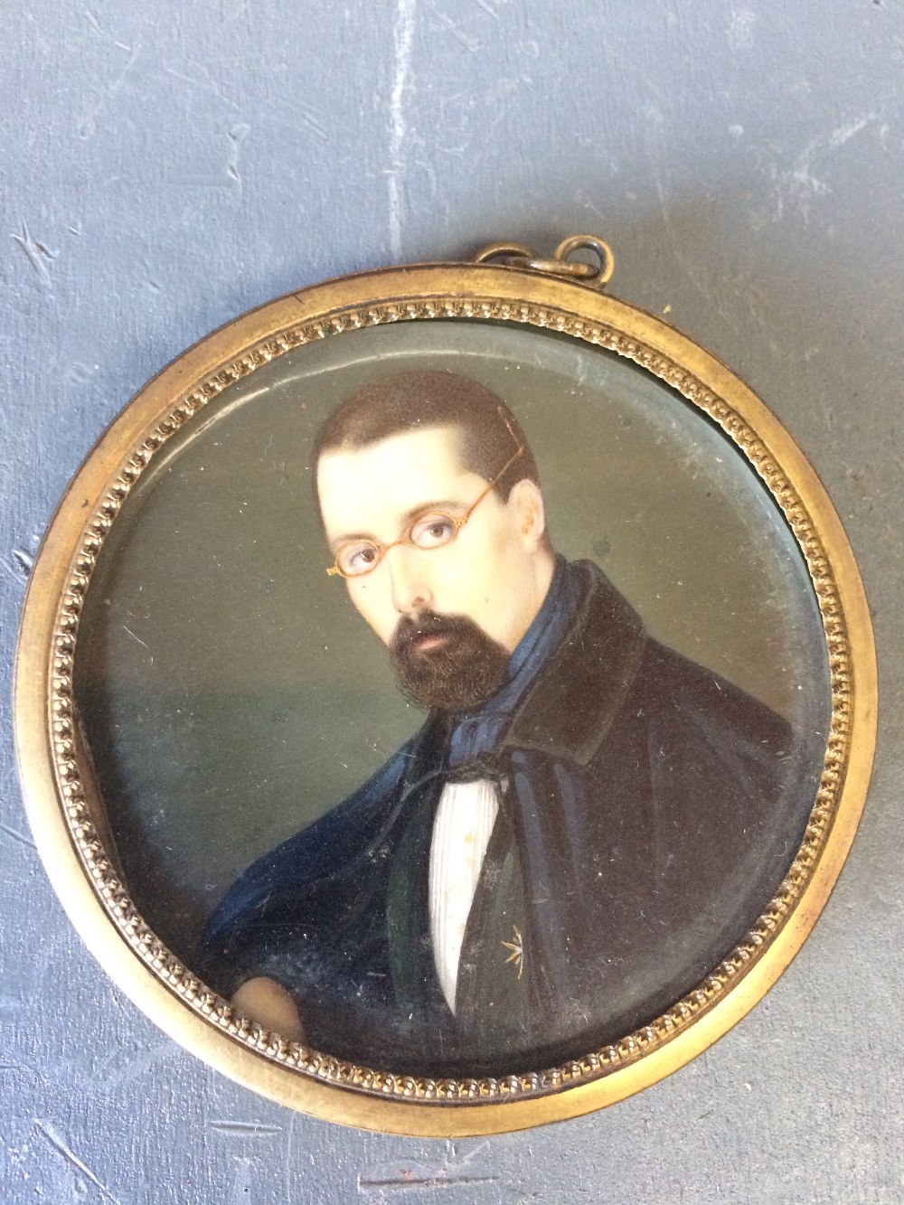 Portrait miniature of a 'Gentleman', head and shoulders, circular in a gilt frame