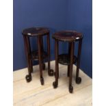 Pair of Chinese hardwood circular top two tier occasional tables