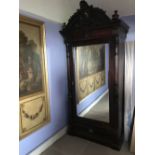 Large stained pine/mahogany wardrobe with one mirror-glazed door and carved cresting. 113 W x 246 H