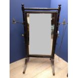 Regency ebonised cheval mirror, the rectangular swing plate flanked by ring turned pillars with a