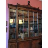 George III mahogany breakfront part glazed library bookcase below a moulded swept cornice with