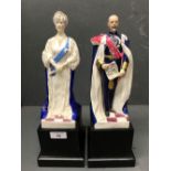 Pair of Royal Worcester porcelain figures of HM King George V and Queen Mary, each on ebonised