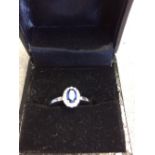 18 carat white gold, oval shaped, sapphire and diamond ring of 90 points